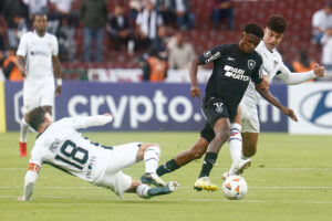 Jeffinho do Botafogo disputa a bola cercado por jogadores da LDU